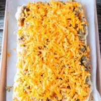An extra layer of cheese is added over the chicken filling in the chicken sliders