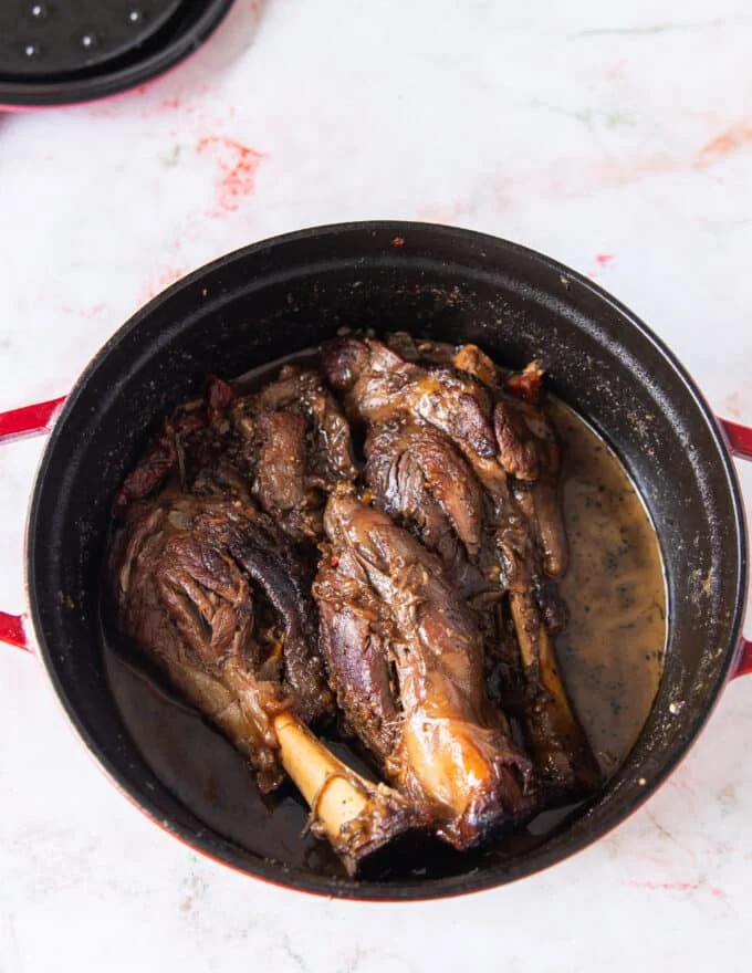 slow cooked lamb shanks that are fork tender and fall off the bone