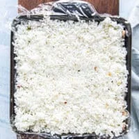 A final layer of the remaining rice is added on top and pressed down