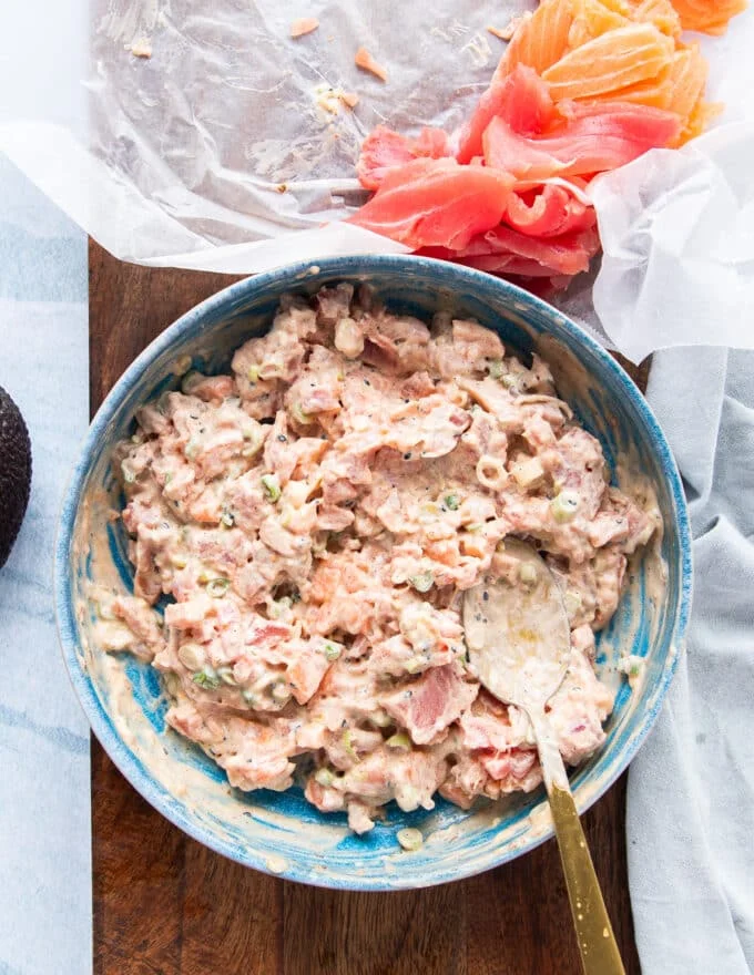 The diced fresh seafood tuna or salmon is added and mixed into the aromatic sauce bowl to make the filling for the sushi cake