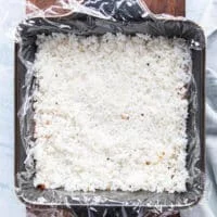 First layer of rice is added to the sushi cake and pressed firmly