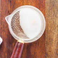 rice seasoning ingredients are all added into a small pot to warm up and dissolve the sugar and salt in the vinegar