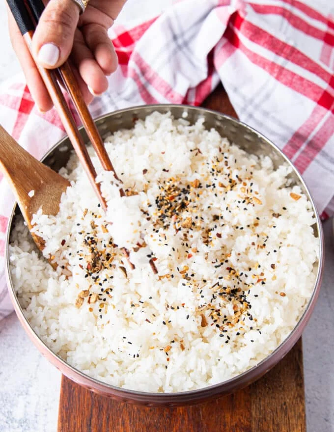 two chopsticks eating sushi rice showing close up of the texture