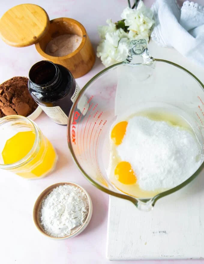 Ingredients used to make chocolate brownie pudding in a large board
