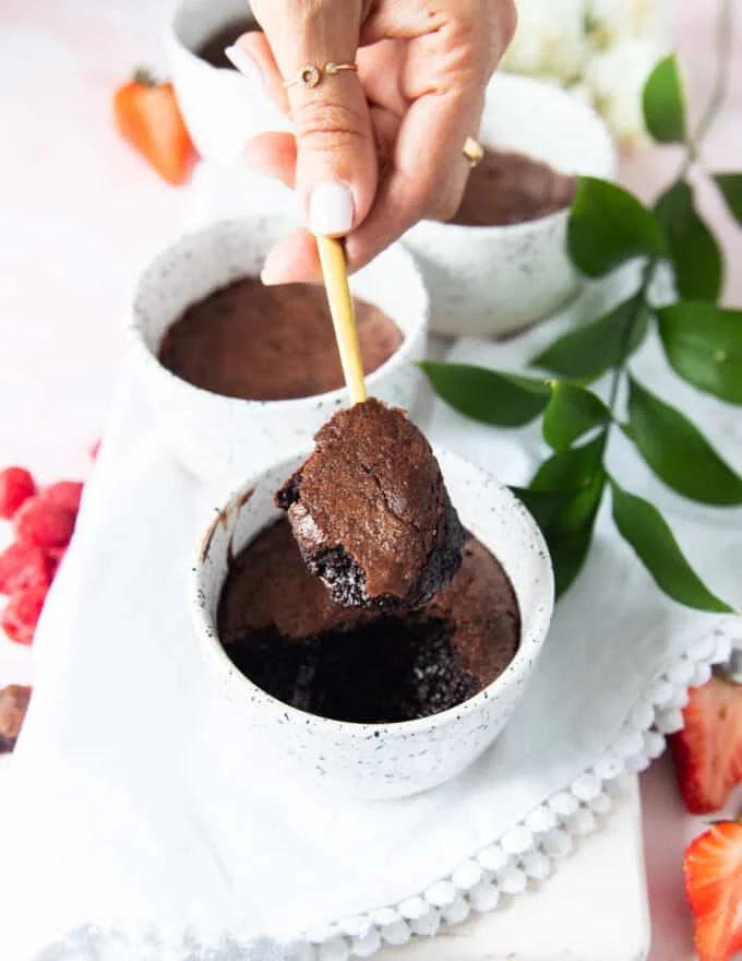 A spoon showing a scoop of the brownie pudding with the crackled tops and fudgy soft inside
