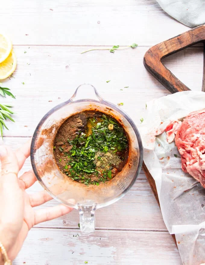 the marinade ingredients added to the bowl of onion water