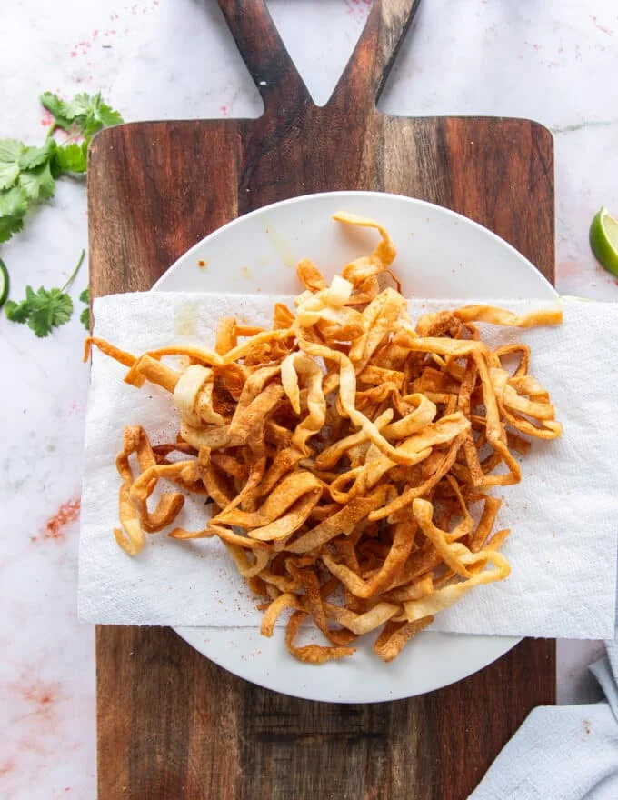 homemade tortilla strips on paper towels draining