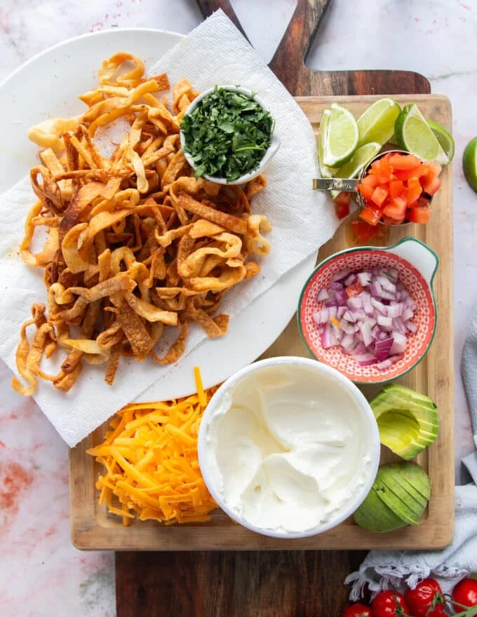 taco soup toppings put aside on a board ready to use