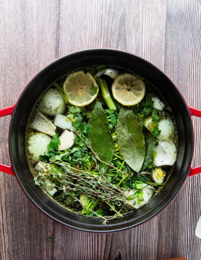 Aromatics added to a large pot with water