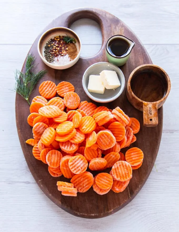 Ingredients needed to make maple glazed carrots, each in small bowls