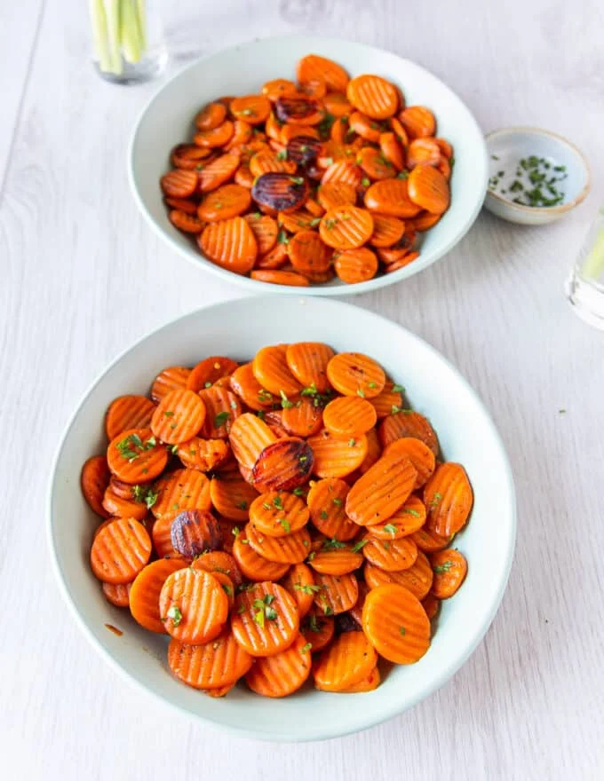 final serving platter of maple glazed carrots with golden perfectly cooked carrots finished with herbs