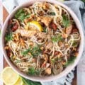 top view of a bowl of tuna pasta with fresh dill and lemon slices