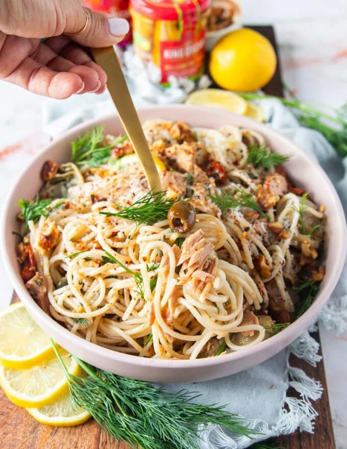 A fork eating some tuna pasta and swirling the pasta in the bowl to show the textures