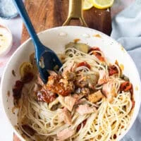 cooked pasta and tuna chunks are added to the sauce pan