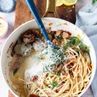Some pasta water and parmesan cheese is added gradually to the saucepan to emulsify the sauce