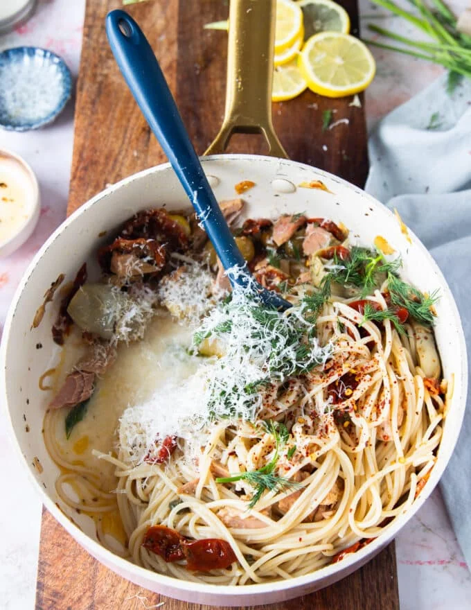 Some pasta water and parmesan cheese is added gradually to the saucepan to emulsify the sauce