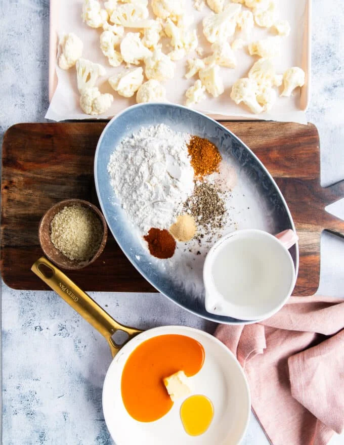 all ingredients used for buffalo cauliflower recipe on a large board