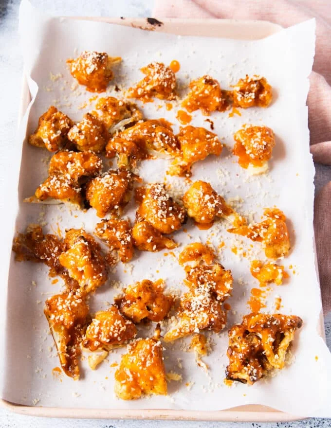 panko is sprinkled over the buffalo sauce coated baked cauliflower