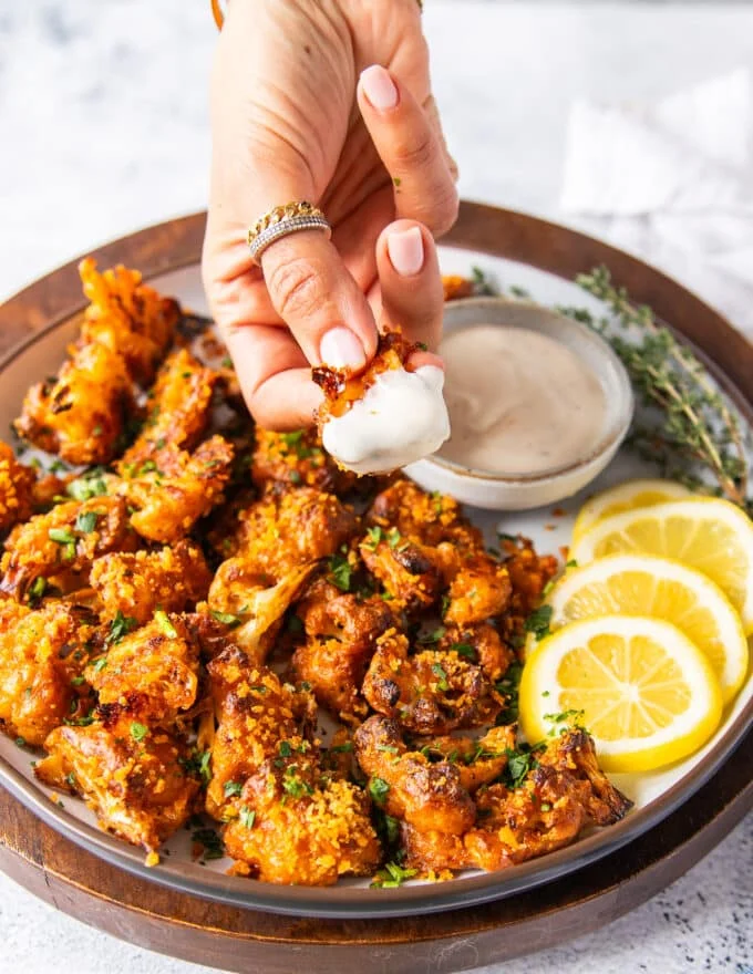 Buffalo cauliflower crispy and dipped and in ranch sauce