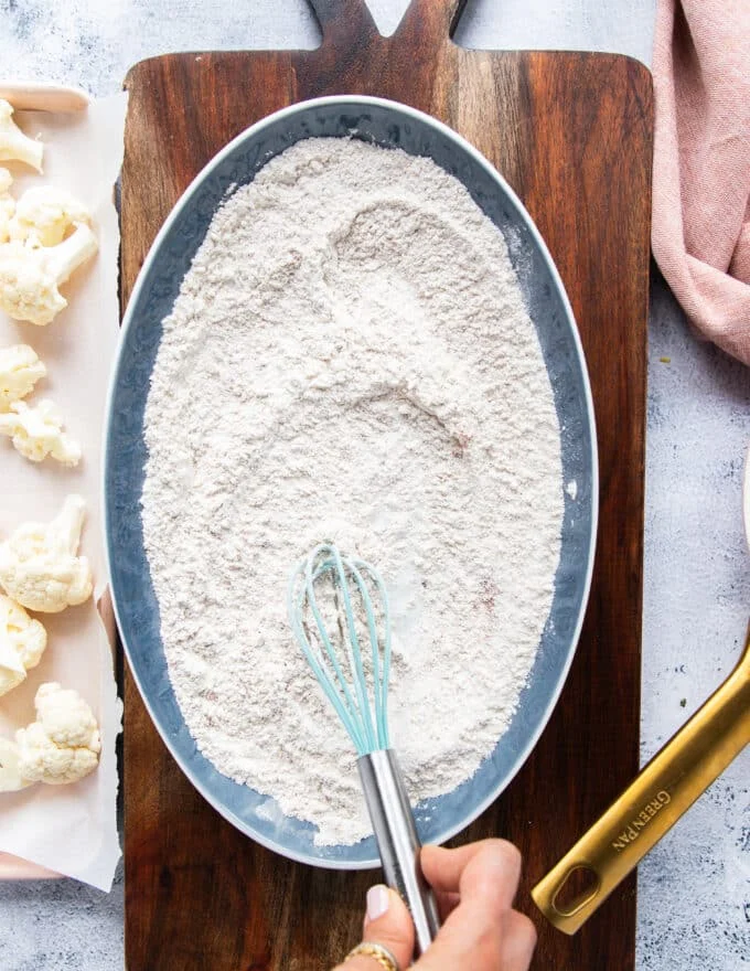 Flour is mixed with seasonings and spices