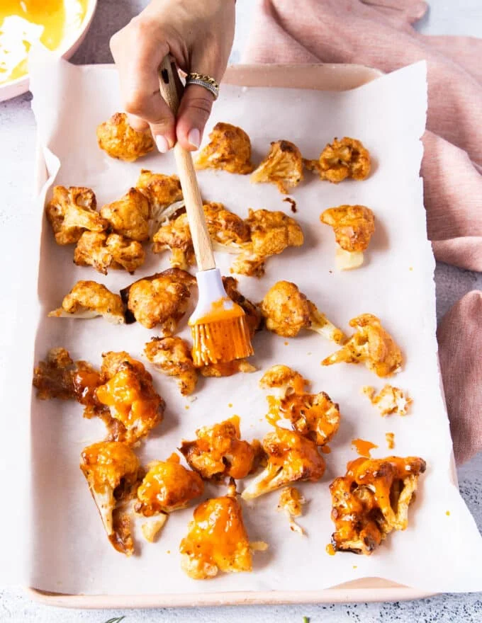 A brush used to brush the buffalo sauce mixture over the crisp cauliflower that's out of the oven.