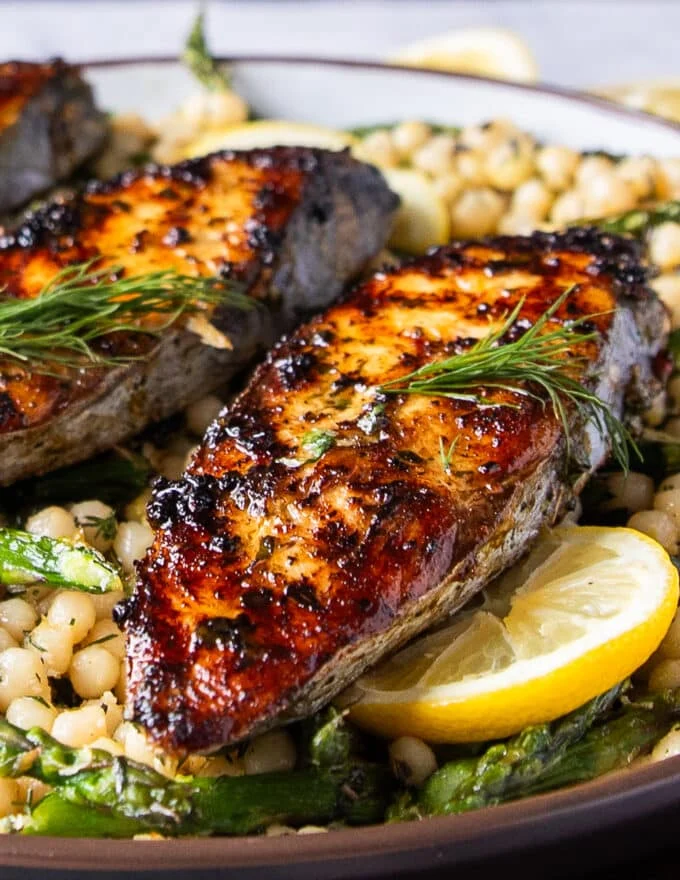 close up of king mackerel grilled to perfection showing the crisp skin and golden color