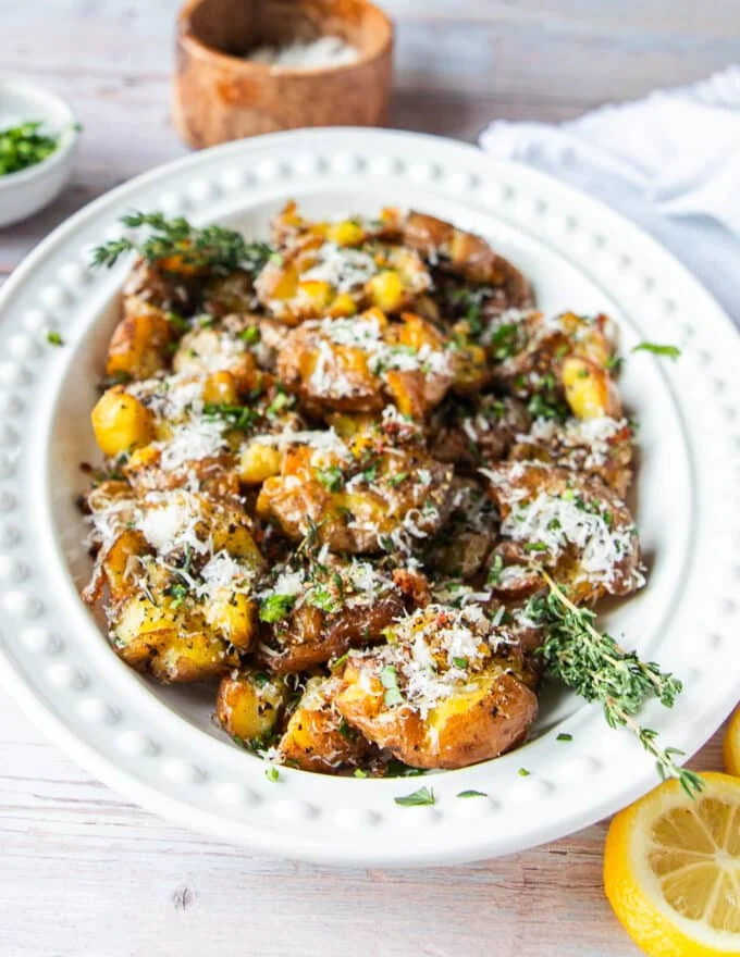 side view of a plate of smashed potatoes ready and crispy