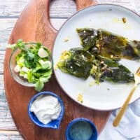 Ingredients for poblano sauce on a board in small boards