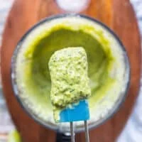 A spoon showing the consistency of the sauce after blending