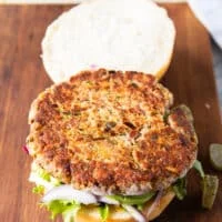 The tuna patty recipe is added over the toppings on the bun