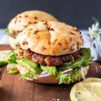 Close up pf a tuna burger showing the tuna burger patty recipe and bun along with the toppings