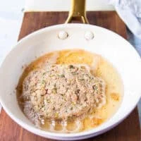Tuna patty added to a skillet