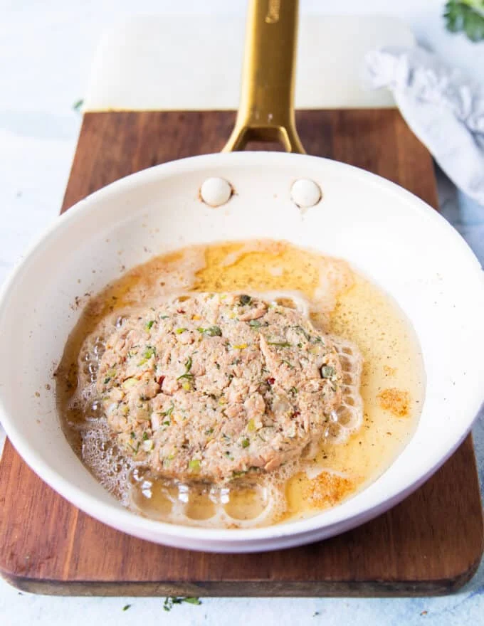 Tuna patty added to a skillet