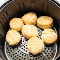 Biscuits golden and cooked in a single layer in the basket of the air fryer