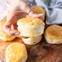 A hand holding a fluffy air fryer biscuit close up