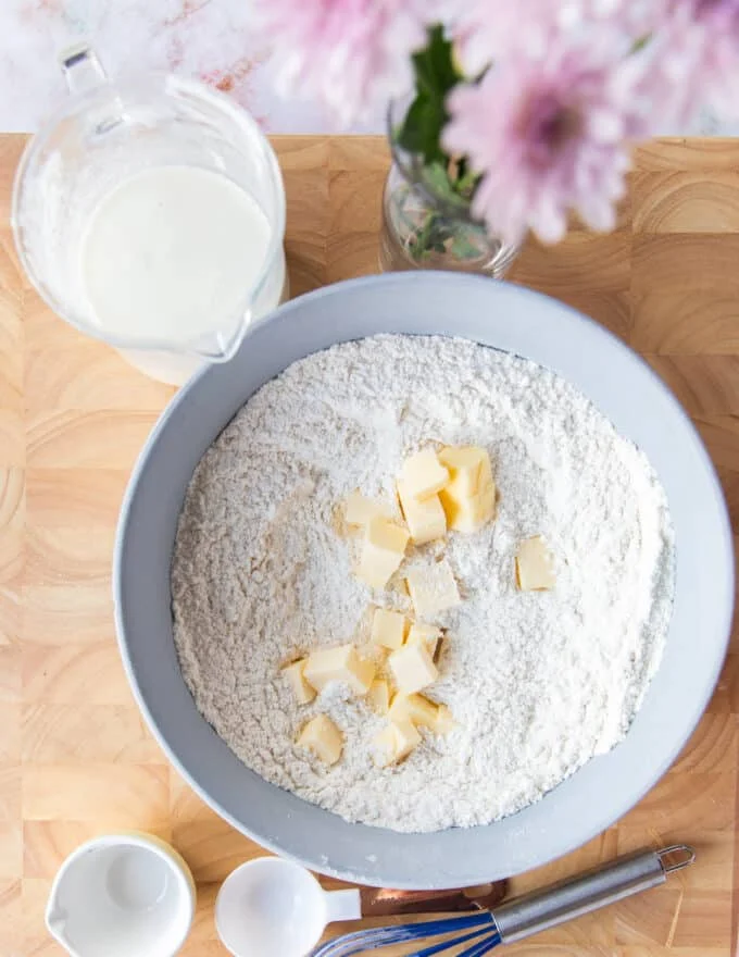 Cold butter pieces added to the flour mixture bowl