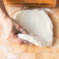 The biscuit dough is rolled to a half inch thick