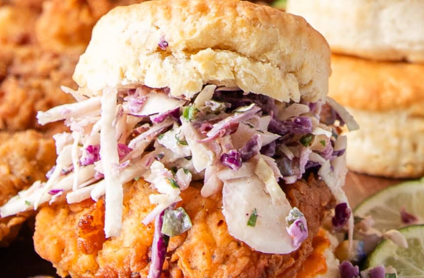 Chicken Biscuit layered with corn slaw and spicy chicken and biscuits