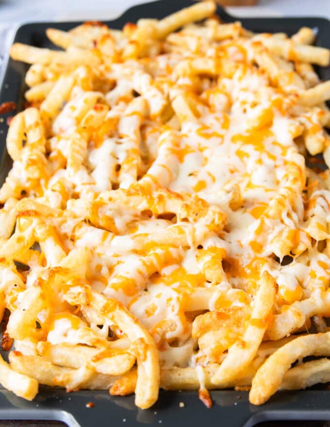 melted cheese over the fries out of the oven ready to be loaded