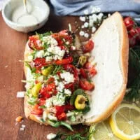The fresh ingredients are added over the creamy sauce on the bread