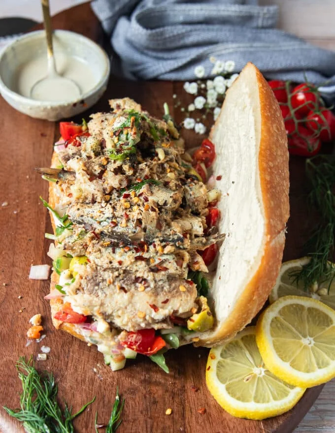 Sardines are added over the the veggies and salad ingredients