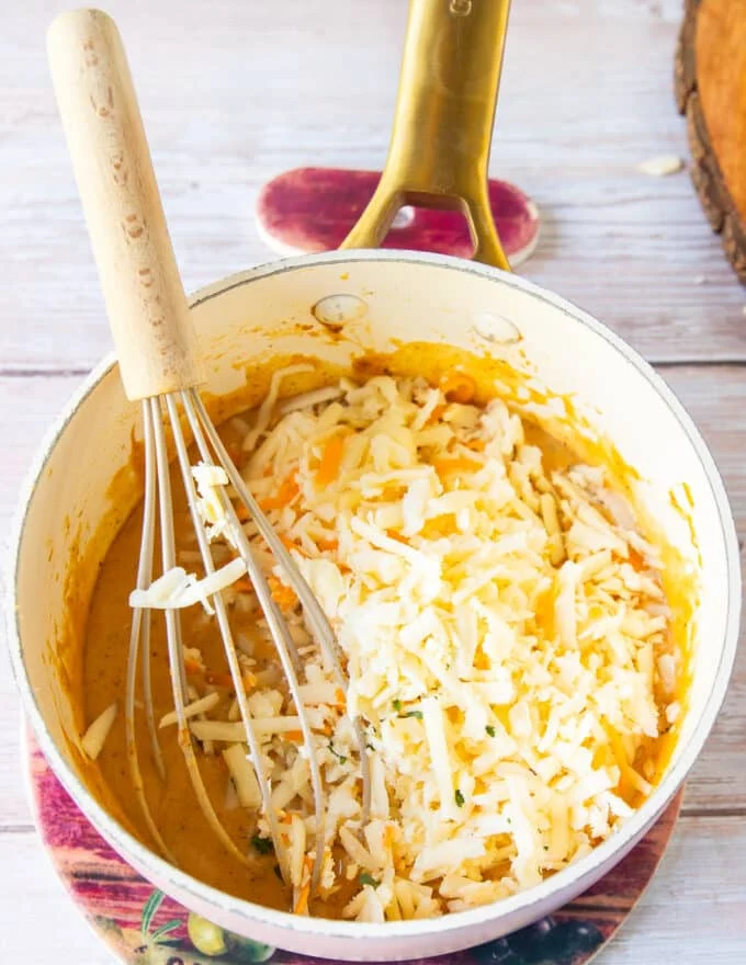 Shredded cheeses are added to the pan