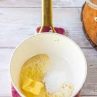 Butter and flour are added to a pan to make the base of the queso