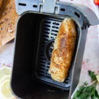 cod arranged in a single layer in an air fryer basket