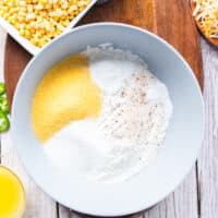 A bowl with the dry ingredients being mixed in to make jalapeno cornbread