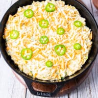 grated cheddar cheese and sliced jalapenos are added over the top of the batter before baking
