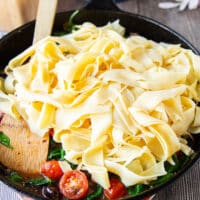 the cooked pasta is added to the sauce in the same pan
