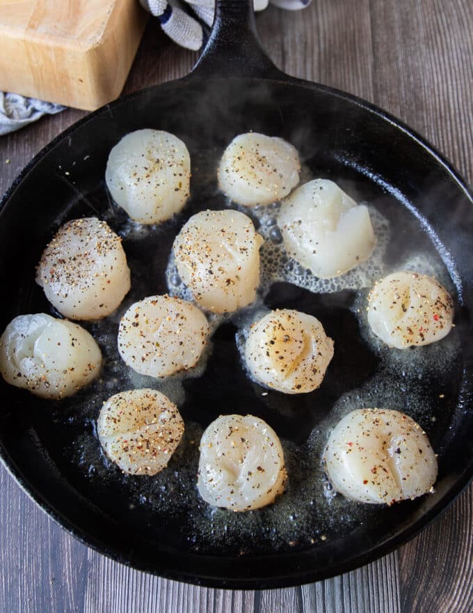 Scallops added to a hot pan for searing in butter